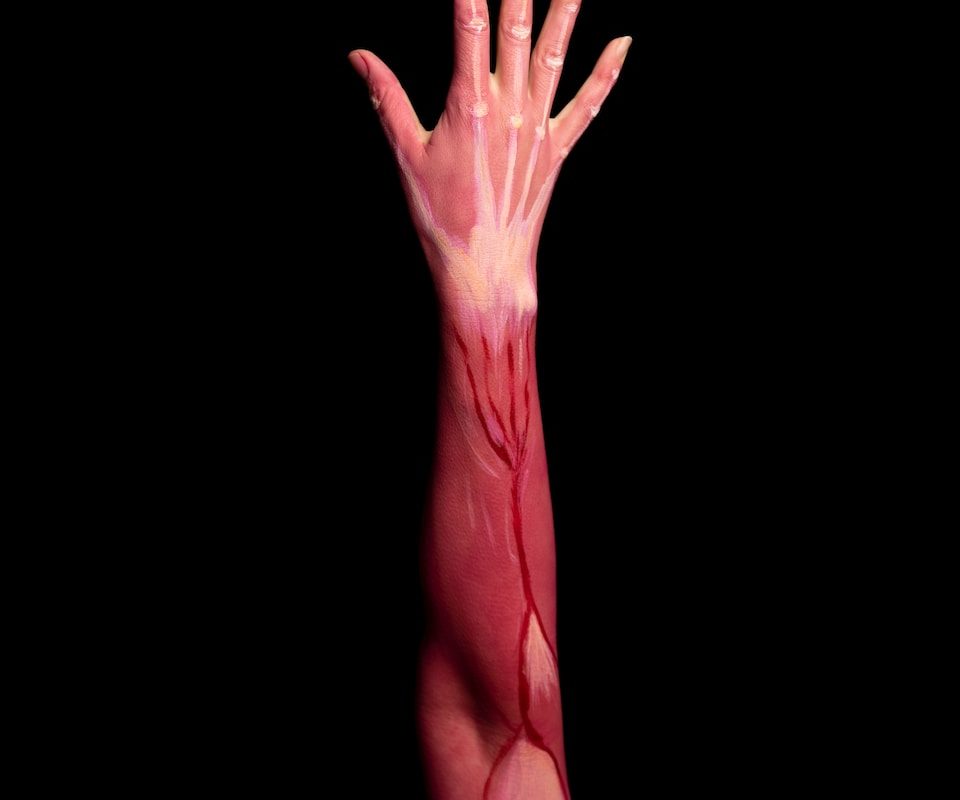 persons left hand with pink paint