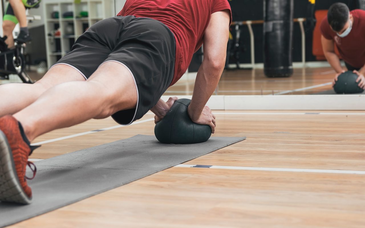 a person doing a plank on a barbell